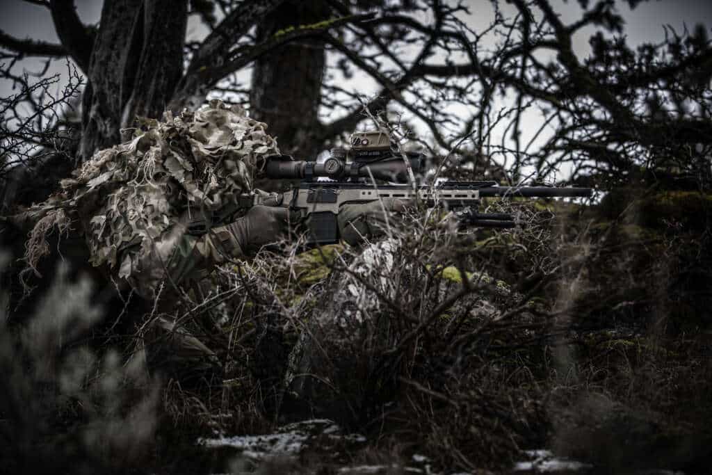 The Thunder Ranch Designated Marksman course is designed for precision shooters who need to achieve first-round hits and rapid follow-ups on diminished size targets at known and unknown distances. Over four intense days, you’ll face challenging scenarios that test your mental and physical resilience.

This advanced rifleman’s class builds on decades of refined curriculum, offering the ultimate training experience for Armed Professionals and Citizens alike. You’ll dive straight into gathering data and engaging properly identified targets, learning to perform under pressure and in challenging positions. The course emphasizes shooting from real-world locations such as loopholes, hides, vehicles, and elevated or awkward positions (the dreaded sloped roof). Additionally the course covers camouflage, terrain utilization, and the critical roles of shooter and spotter.

You’ll be provided with a DOPE book and taught how to use it effectively, with the chance to gather data using a chronograph. The course also includes training on ballistic apps, although physical DOPE collection and knowledge is prioritized. Working in shooter/spotter teams, you’ll gain practical experience and develop teamwork, wind calling, and other critical skills. This advanced, demanding course utilizes Thunder Ranch’s expansive 850 acre facility and is ideal for Armed Professionals and citizens alike seeking to enhance their skills.